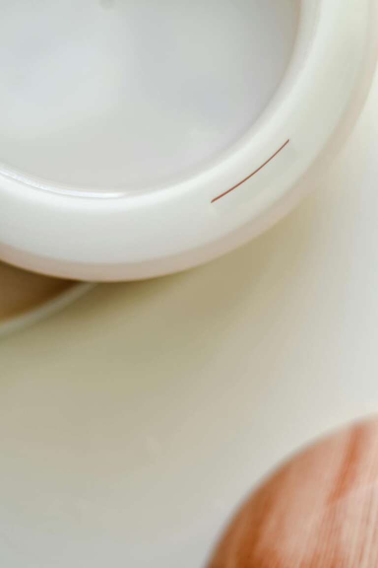 Elegant close-up of an essential oil diffuser on a white surface, perfect for spa and relaxation themes.